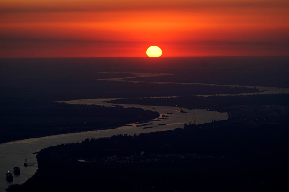 Ships travel along the Mississippi River in LaPlace, La., as the sun sets on Friday, Oct. 20,...