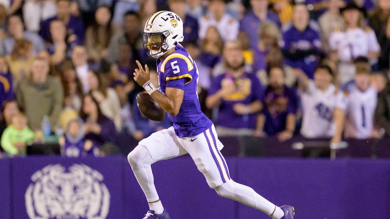 LSU quarterback Jayden Daniels (5) runs during the first half of an NCAA college football game...