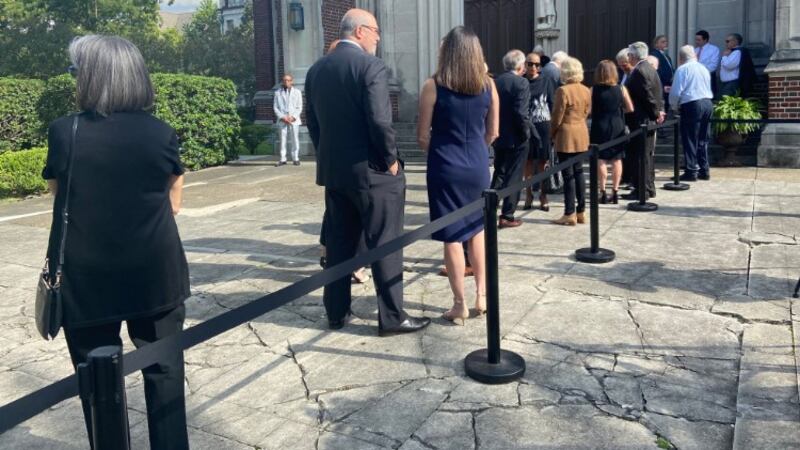 Mourners line up outside Uptown New Orleans' Holy Name of Jesus Catholic Church on Saturday...
