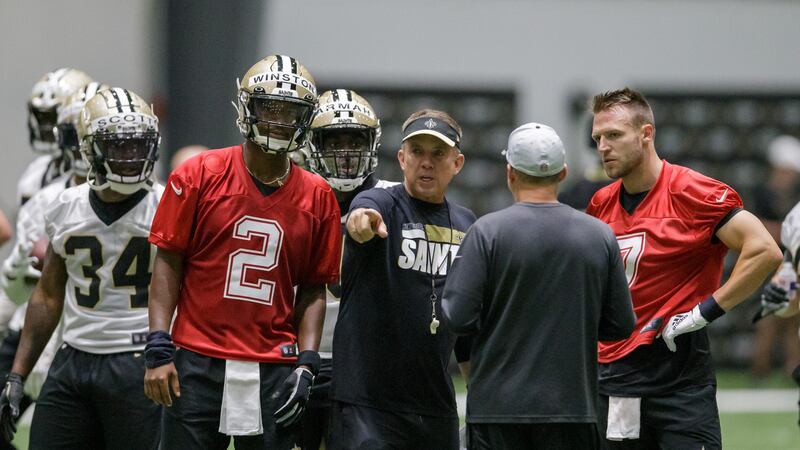 New Orleans Saints head coach Sean Payton, center, gives instruction to New Orleans Saints...