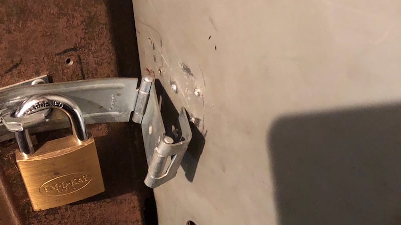 Someone busted the hinge that holds a lock to the door of the evidence room at criminal court...