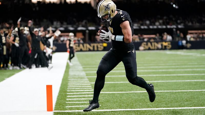 New Orleans Saints' Taysom Hill scores a touchdown during the first half of an NFL football...