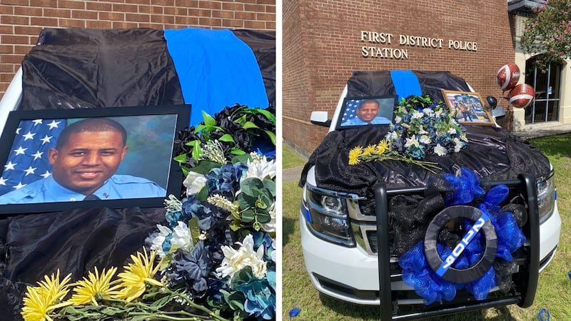 NOPD detective Everett Briscoe's police unit was decorated with flowers, a photo and a flag...