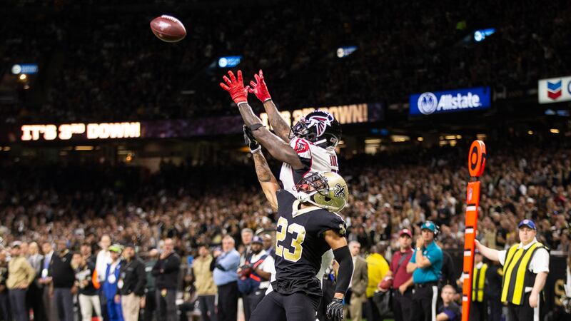 Saints CB Marshon Lattimore leaps to contest a ball thrown to Falcons WR Julio Jones
