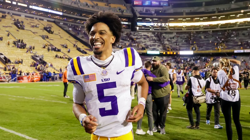 LSU quarterback Jayden Daniels (5) runs off the field following a 52-35 victory over Florida...