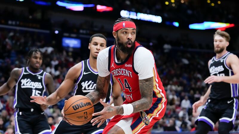 New Orleans Pelicans forward Brandon Ingram (14) looks to pass under the basket in the first...